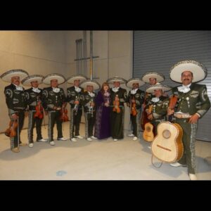 musicians posing for a picture with a lady