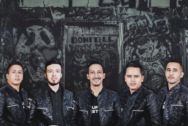 A close shot of musician band posing black and black dress combo