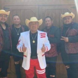 Musicians standing at wooden doors with the cow boy hats