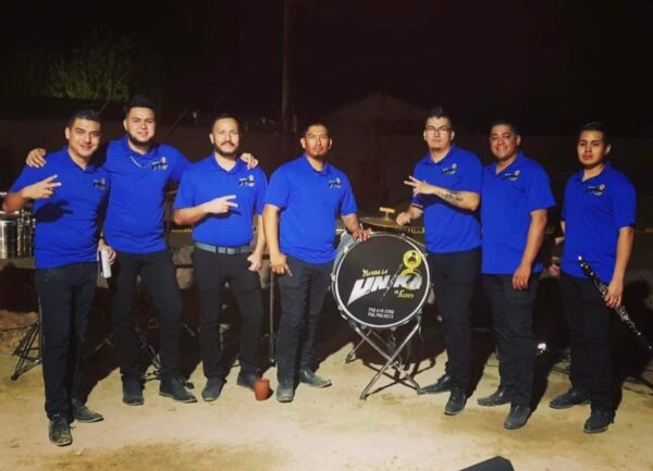 Banda Lv musicians dressed up in black and blue posing for a picture