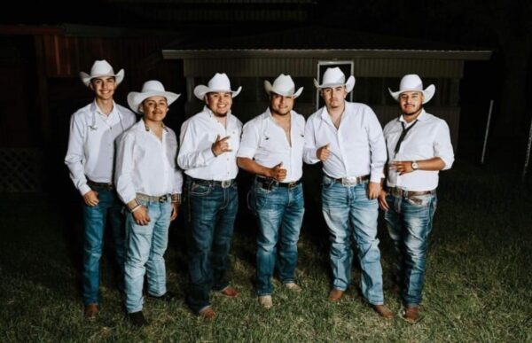 musicians band in white shirts posing for a picture