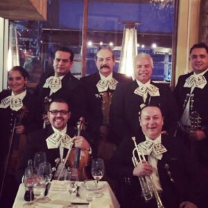 Mariachis Lv BAND WITH white bow shaped on their shirt