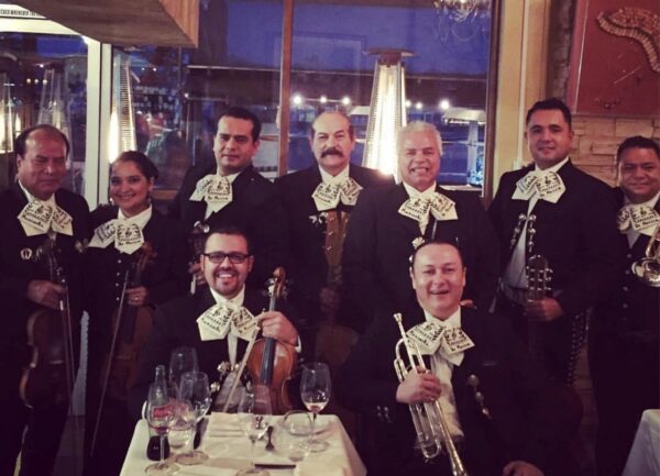 Mariachis Lv BAND WITH white bow shaped on their shirt