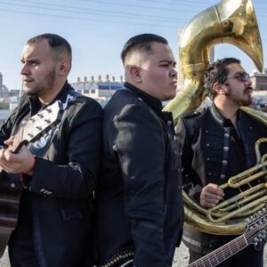 Man in black dress carrying French horn