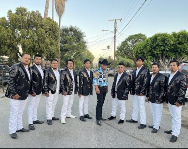 A man posing for a picture with musician band