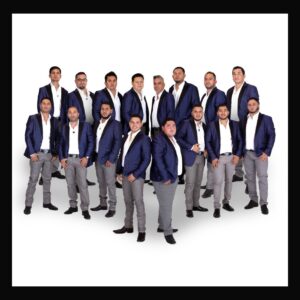 musicians in blue jacket with their hands in pocket posing for a picture