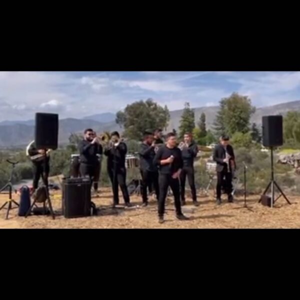 Music band with their instruments and speaker setup in an open area