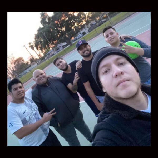 Music band taking selfie at the ground