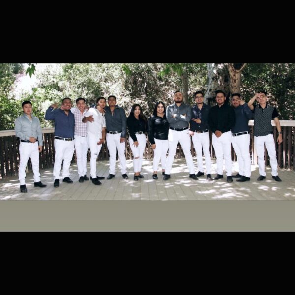 Music band all in white pants posing for a picture