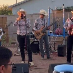 Musicians singing on mic and playing accordion and guitar