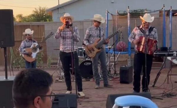 Musicians singing on mic and playing accordion and guitar