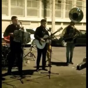 Musicians playing instruments and singing on road