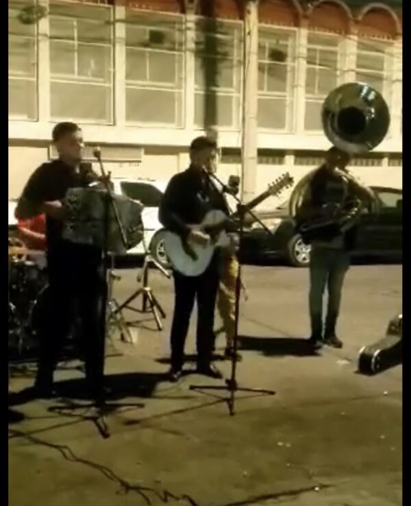 Musicians playing instruments and singing on road