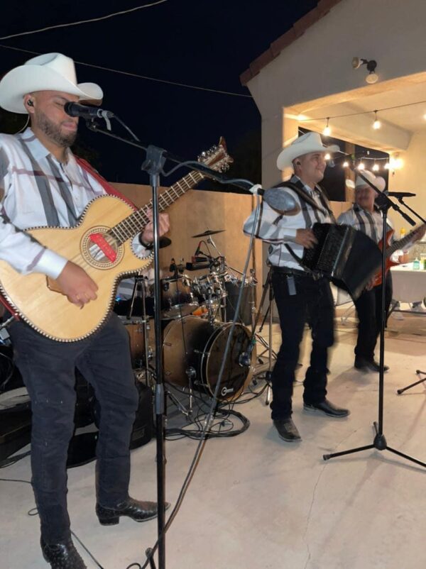 Musicians with white cow boy hats playing guitar and accordion