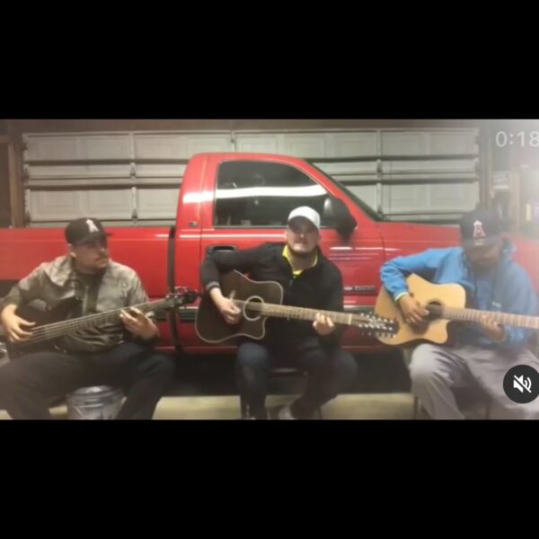 Musicians playing guitar near the truck