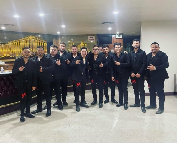 Music band all dressed up in black and red colour ribbon tied on their knees