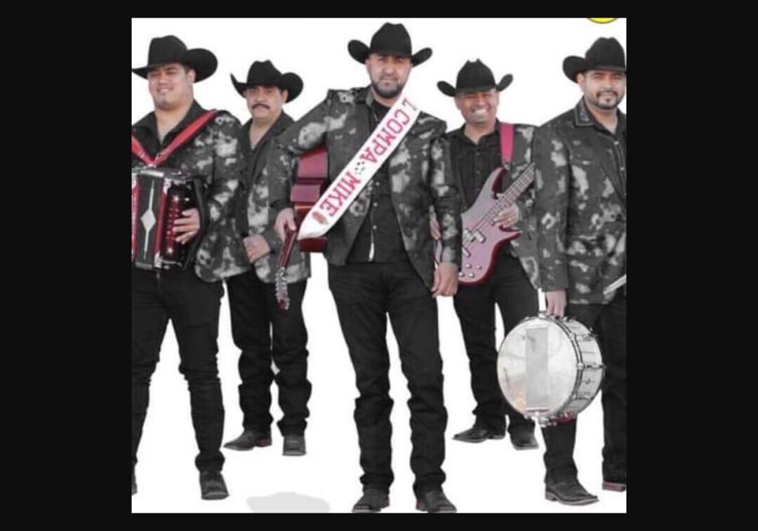 Musician with their instruments and cow boy hats posing