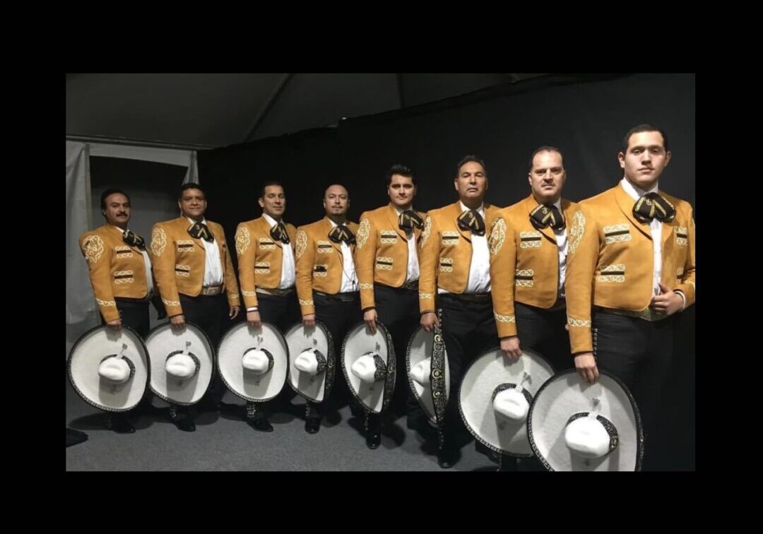 All musicians posing with their white cow boy hat and dressed in yellow and black