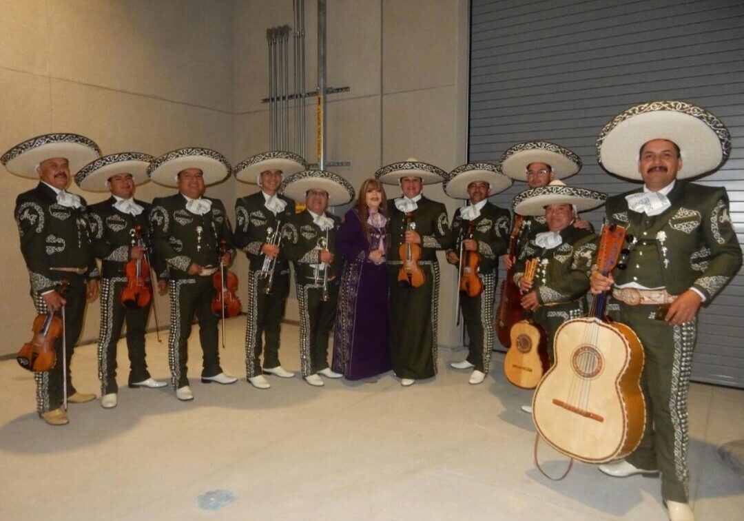 musicians posing for a picture with a lady