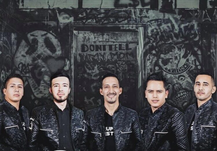 A close shot of musician band posing black and black dress combo