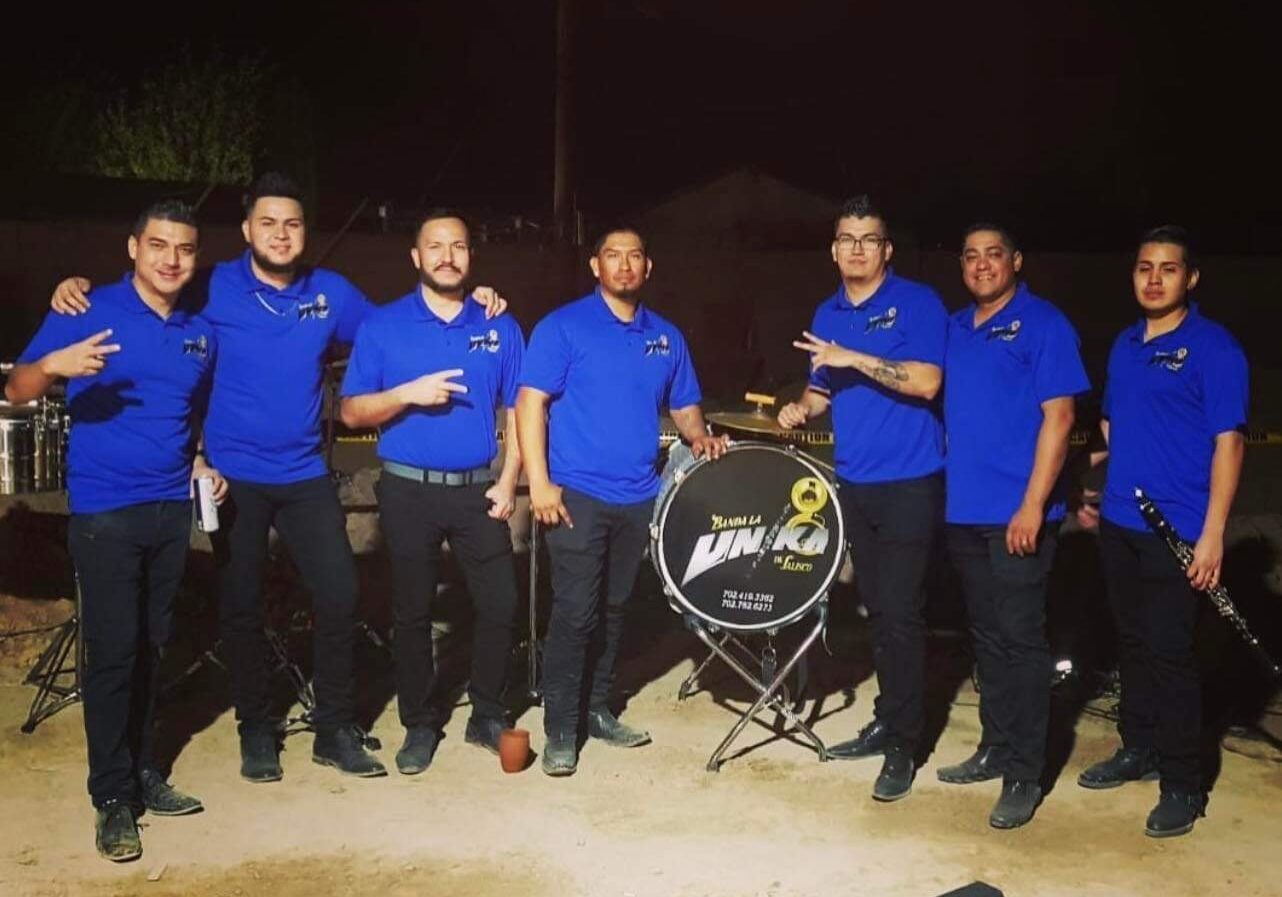 Banda Lv musicians dressed up in black and blue posing for a picture