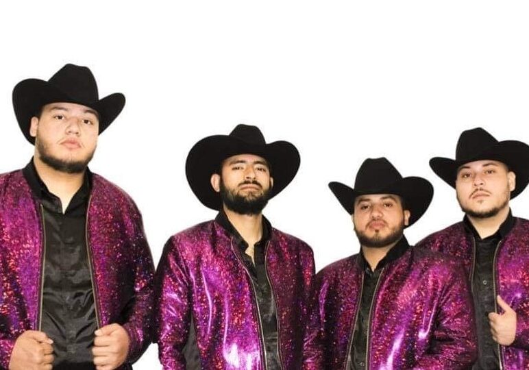 Musicians in glittering pink jackets and cow boy hats
