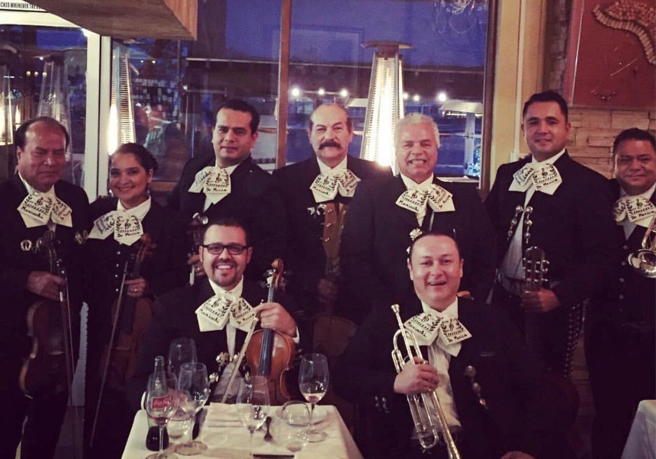 Mariachis Lv BAND WITH white bow shaped on their shirt