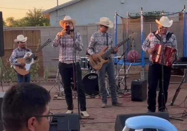 Musicians singing on mic and playing accordion and guitar