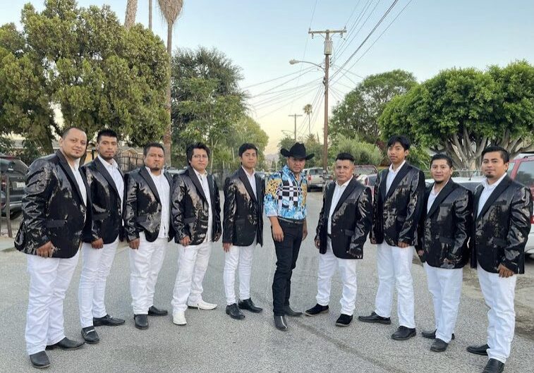 A man posing for a picture with musician band