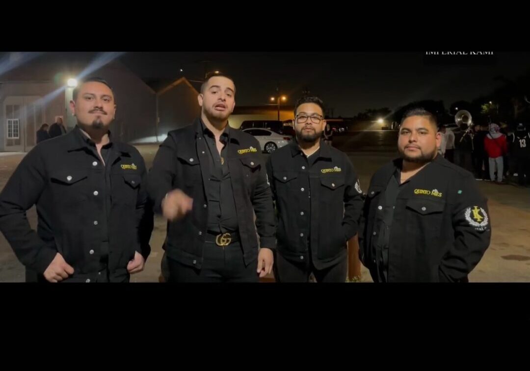 Music band dressed up in black posing on road