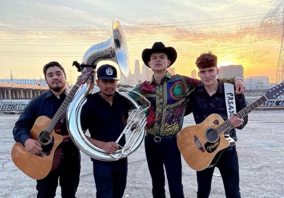 Group of musicians posing with their classical guitar and French horn