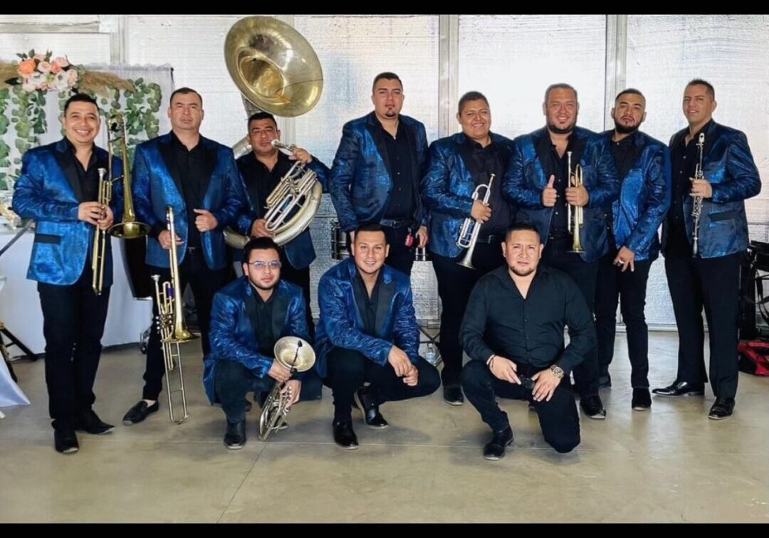 Music band posing for picture with their trumpet