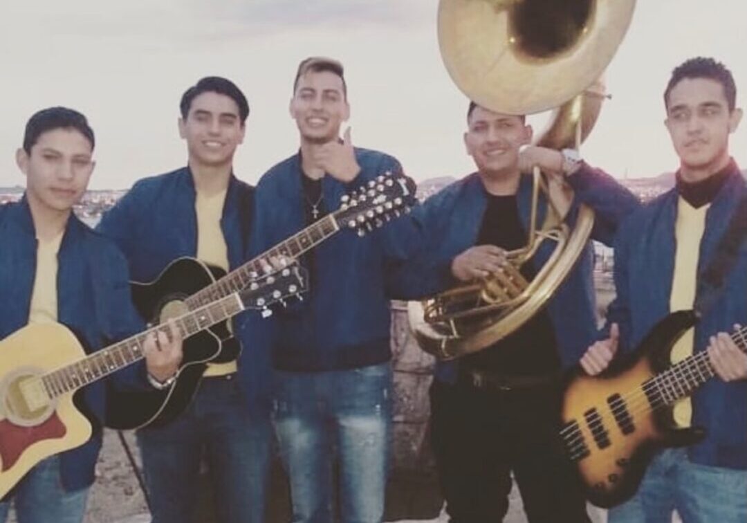 Music band posing for a picture with their musical instruments
