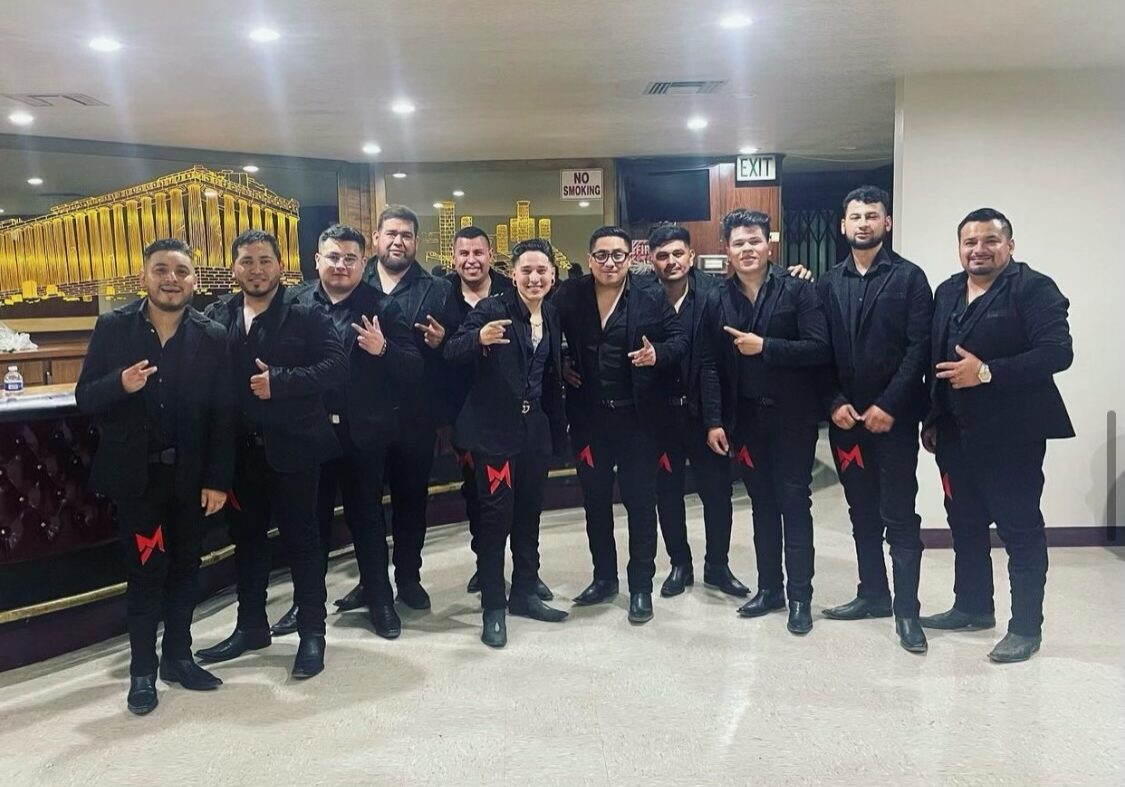 Music band all dressed up in black and red colour ribbon tied on their knees