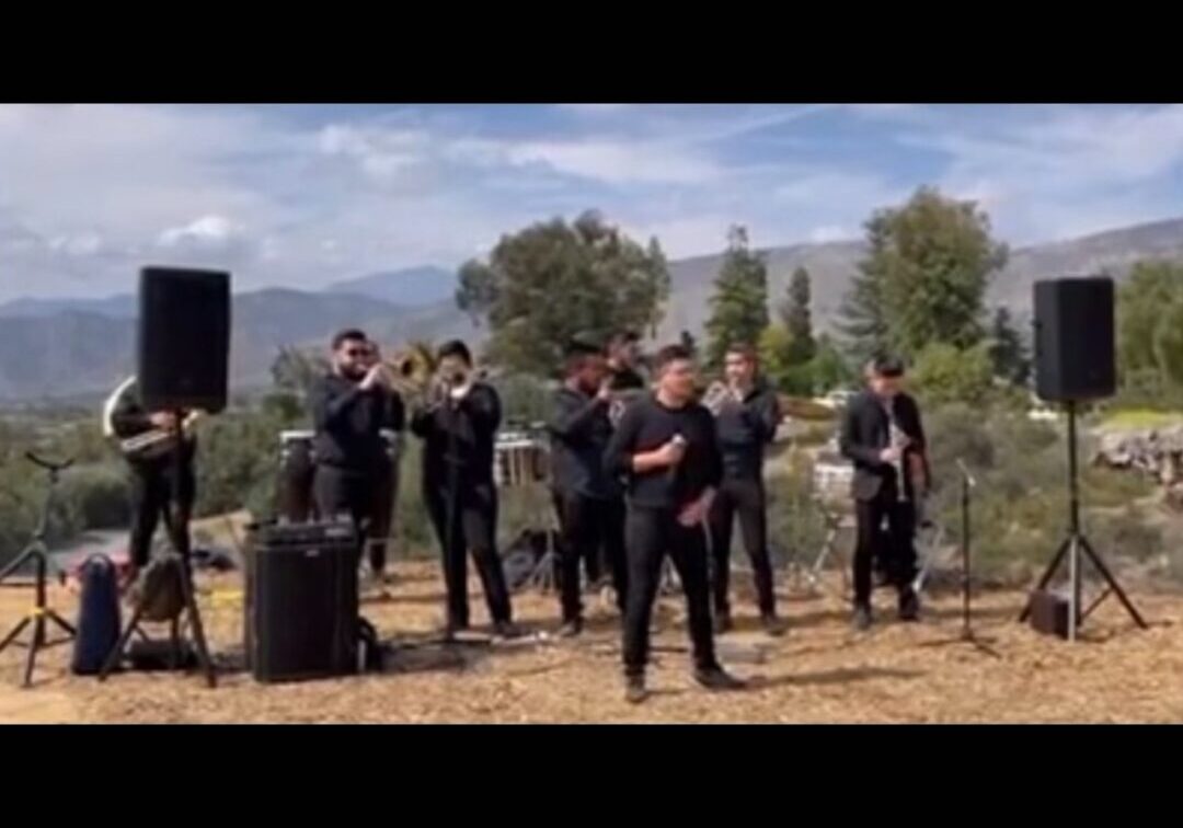 Music band with their instruments and speaker setup in an open area